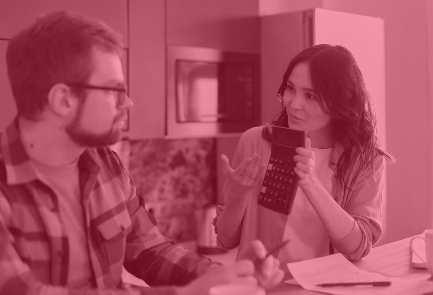 woman holding a calculator for a man to see