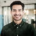 man in an office space with a green shirt