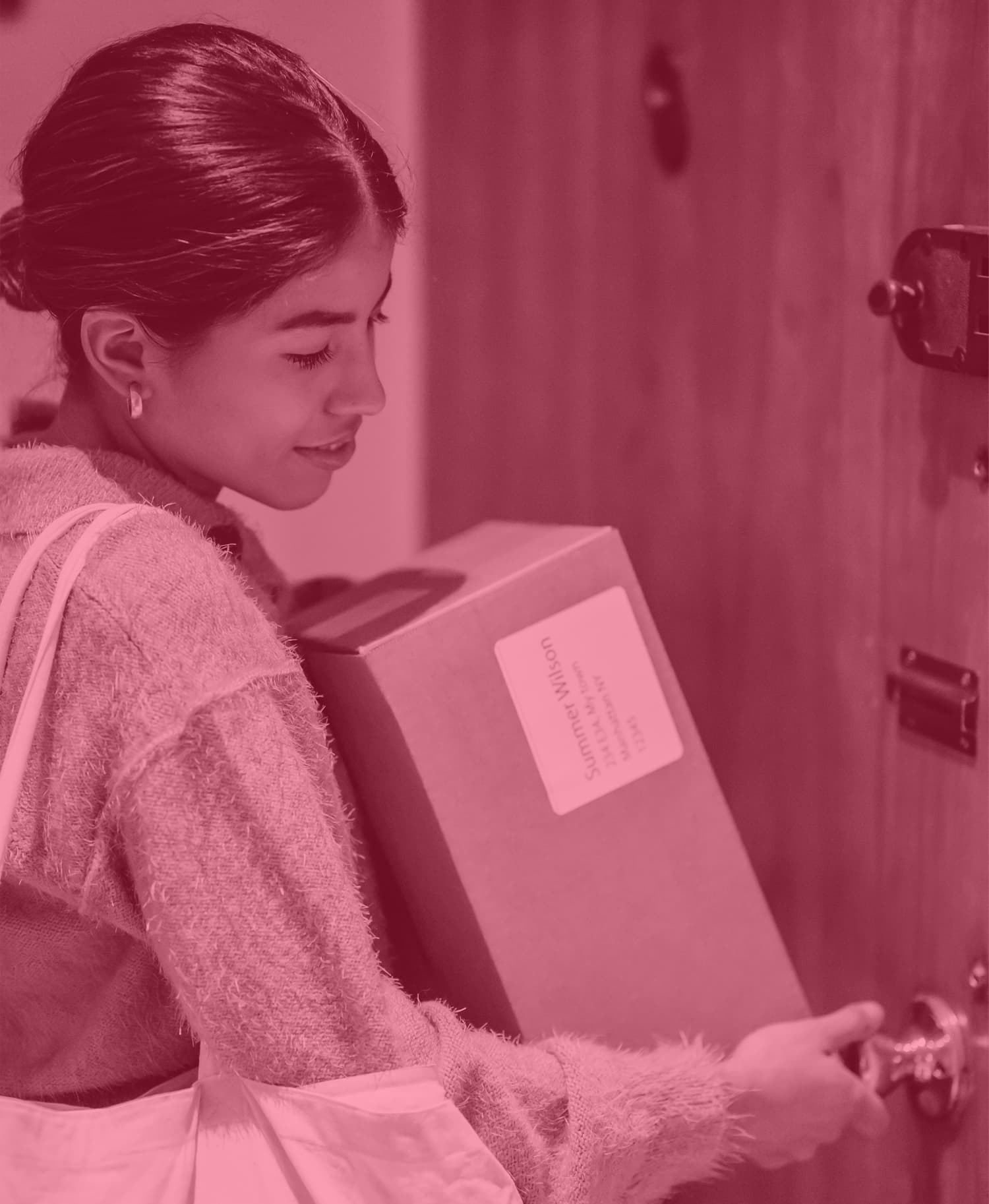 woman opening a door with package